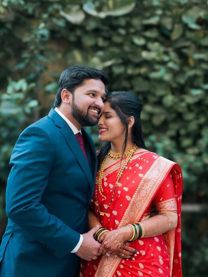 A cozy and romantic moment between the couple, dressed in beautiful traditional attire. Their comfortable embrace and soft smiles say everything.