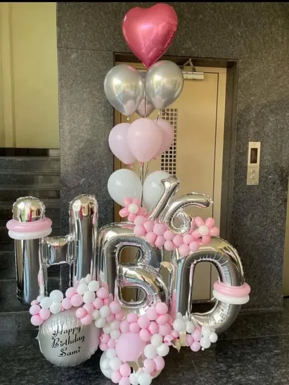 A beautiful and personalized "HBD" balloon bouquet. This arrangement in pink, white, and silver is a great way to surprise someone and can be delivered anywhere in Mumbai.