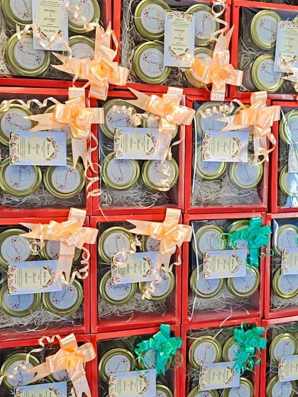 A top-down view of the four-jar wedding hampers, showing the neat arrangement and custom tags.