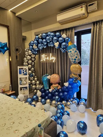This view shows how the welcome home balloon setup transforms a bedroom corner into a festive photo spot.