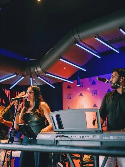On stage performing for an Embassy corporate event. Our dual lead vocalists, Shanelle and Aryaman, engage the crowd while the band lays down a solid groove.