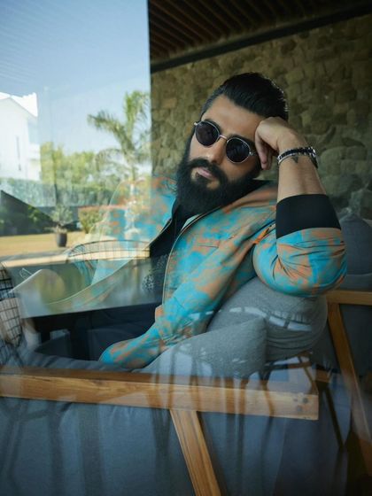 Using reflections to create a layered, artistic shot for Arjun Kapoor's Exhibit Magazine spread. The patterned Diesel jacket becomes the focal point, showcasing a more eclectic and fashion-forward style.