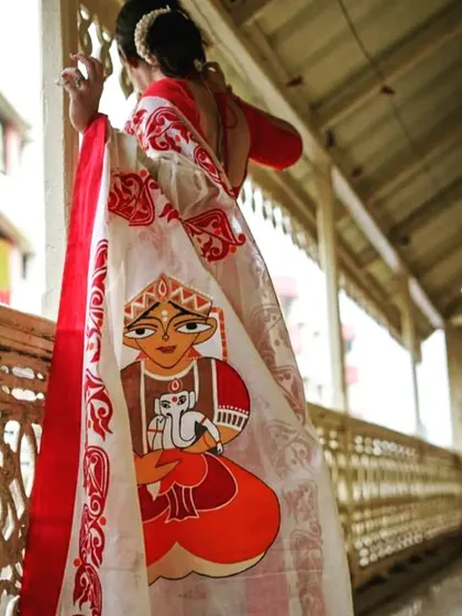 Another view of the hand-painted saree, showing the artwork on the pallu in more detail. This piece is perfect for anyone looking for a unique and artistic take on the traditional look.