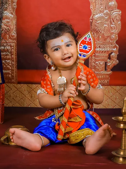 We celebrate culture and tradition with unique photoshoots. This little one is dressed as Lord Murugan, a theme we designed with custom outfits and props to create a divine and memorable portrait.