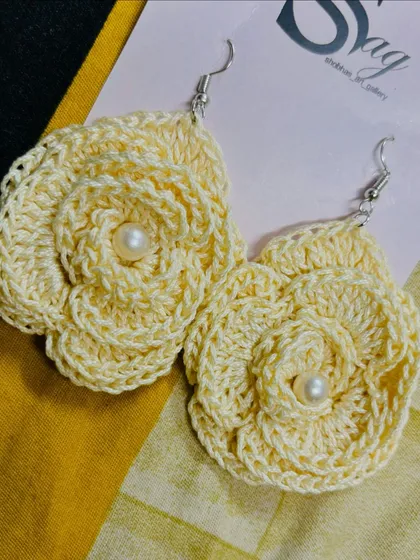 A pair of my handmade rose earrings with pearl centers. This design is a versatile piece of floral jewelry that can be dressed up or down.