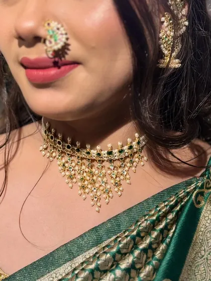 A close-up shot of the pearl and green stone choker, showing how beautifully it sits.