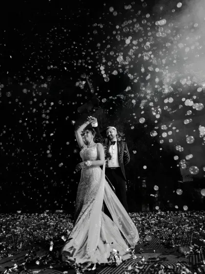 Under a sky of bubbles, the Sangeet night comes alive. I use dramatic lighting and creative angles to capture the energy of the dance floor and the couple's effortless rhythm.