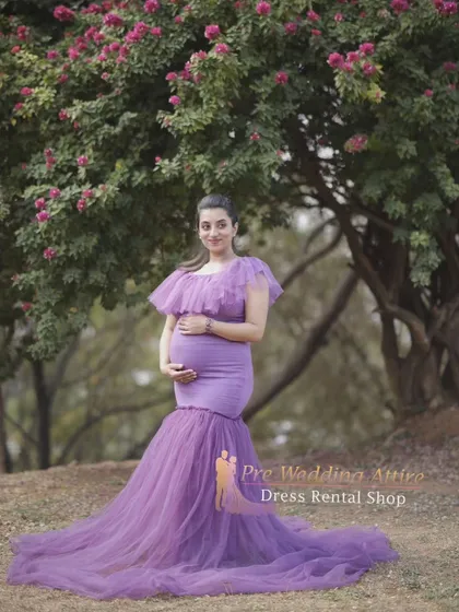 The lavender mermaid gown looks ethereal in a natural, wooded setting. The soft purple color and delicate tulle create a dreamy atmosphere for your maternity portraits.