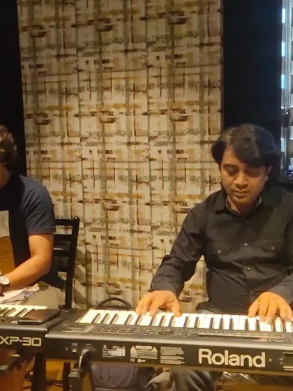 Our talented keyboard players working on the arrangements for the new show. Their skill and creativity are essential to our music.