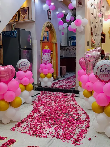 A beautiful home setup for a 'Welcome Baby Girl' event. I created a pathway of pink flower petals leading to a decorative balloon arch, making the family's first steps into the home extra special.