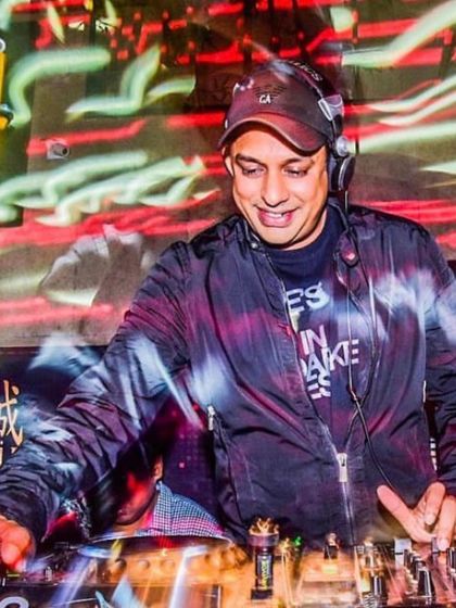 A candid shot from behind the decks during a high-energy set. My focus is always on the dance floor, ensuring the music selection and flow are perfectly matched to the energy of the party.