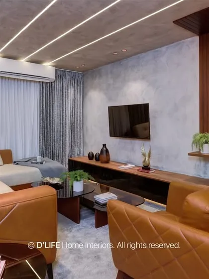 A cozy and inviting living room with a comfortable leather sofa, warm wood paneling, and soft lighting. The space is perfect for relaxing and unwinding.