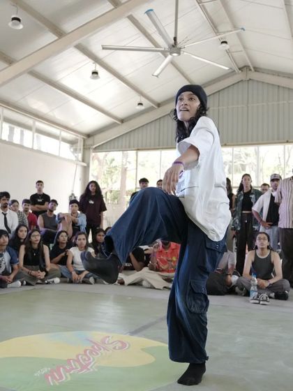 A dancer hitting a powerful pose during a battle at Spectra. The cypher is a space for bold expression and pushing your own limits.