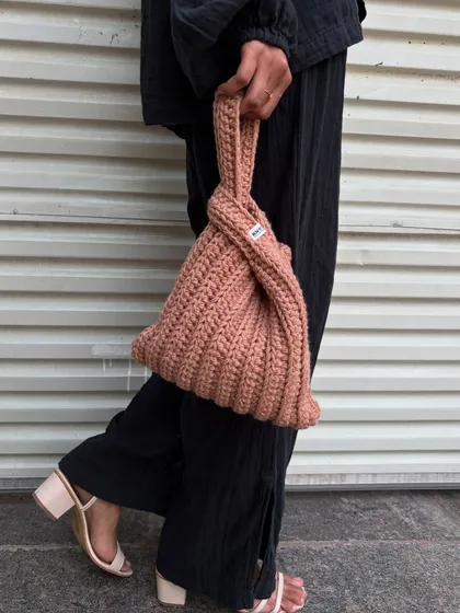 This is my take on the Japanese Knot Bag, a super chic and minimalist accessory. The unique design lets you loop the long handle through the short one to create a secure closure. It’s perfect for when you want to carry just the essentials with effortless style.