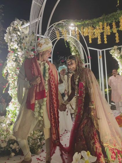 A candid, happy moment between the bride and groom at their Udaivilas wedding. We are there to support our couples through every part of their celebration.
