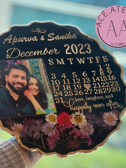 Holding this custom anniversary frame, you can see the depth and detail of the preserved flowers and the elegant gold lettering. It's a substantial and heartfelt gift.