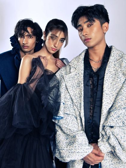 A powerful group portrait with three models, creating a dynamic composition for a high-fashion story. The focus is on attitude and style.