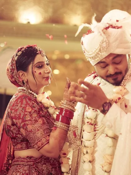 A playful and candid moment during the varmala ceremony, capturing the fun and games that are part of the tradition.
