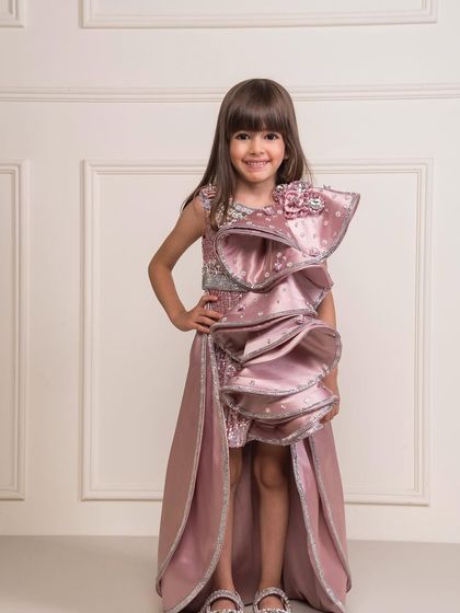 The high low skirt and dramatic ruffle make this dress a unique choice for a birthday girl.