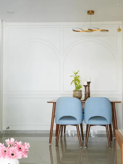 The dining area of the Vora House. We replaced the old, high windows with French windows to flood the space with daylight. The wall moldings and arches add a touch of classic elegance.