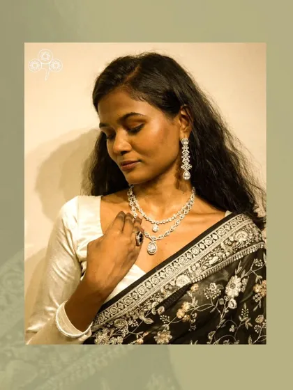 The delicate design of the necklace and earrings adds a touch of grace.