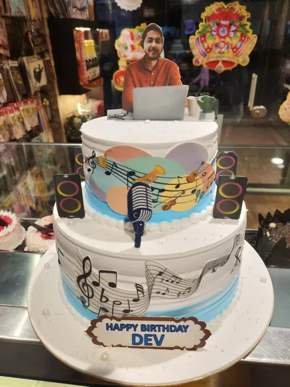 A three-tier cake that hits all the right notes for a music lover's birthday. Decorated with musical notes, instruments, and a personalized photo topper, this cake celebrates a passion for music.