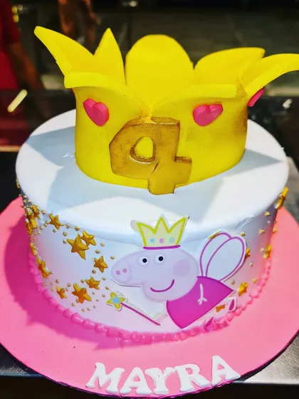A royally fun Peppa Pig cake for a 4th birthday. This design features Princess Peppa and is topped with a large, edible golden crown, making it a delightful treat for any Peppa fan.