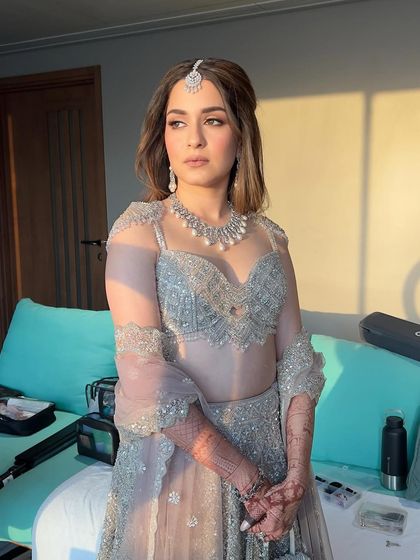 The golden hour light adds a beautiful warmth to this cool-toned outfit. The makeup looks flawless and radiant, proving its versatility in different lighting conditions.