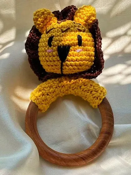 I designed this crochet lion rattle especially for little hands. It's made from 100% baby-safe cotton yarn and features a smooth, natural wood ring, making it a safe and sustainable first toy for a newborn.