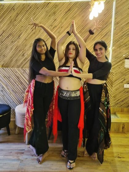 A beautiful trio pose from our Belly Dance class, showcasing symmetry and grace.