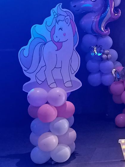 A unicorn character cutout on a balloon pillar, a great prop for photos.