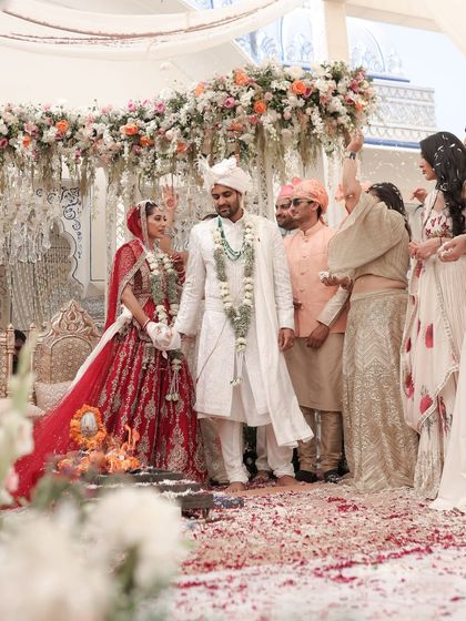A candid moment during the pheras, with the couple framed by the soft pastel florals and the intricate thikri work of the mandap. It's these personal moments within the grand design that I cherish the most.