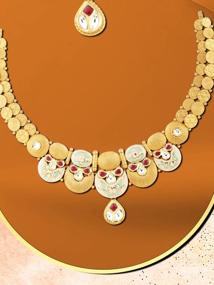 She glows with grace in this contemporary necklace. The design uses circular motifs with red and white enamel, creating a piece that is both elegant and eye-catching.