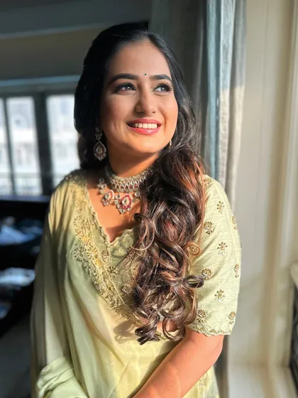 A look of happy anticipation. The soft glam makeup is perfect for her elegant engagement attire.