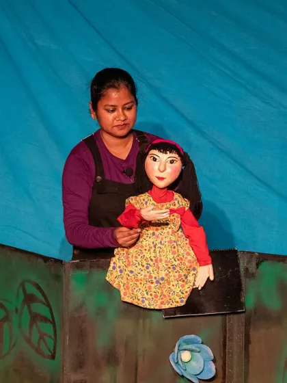 A close-up of the Aisha puppet, showing the detailed craftsmanship and expressive face that helps her connect with the audience.