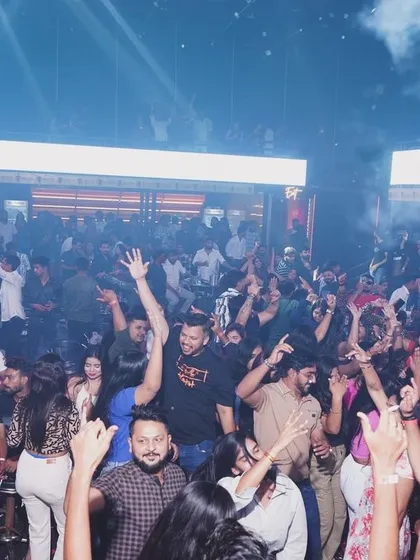 Hands in the air under a haze of smoke at Hyper Club. This is what a high-energy Bollywood set looks like.