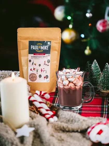 A classic Christmas scene with hot chocolate, a candle, and candy canes. This composition uses props to tell a story of a cozy winter evening.