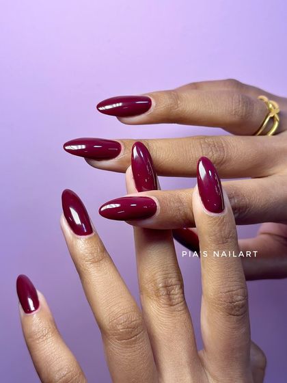 The perfect deep red. This shade, "Mokai," is a classic choice for a bold, confident, and glossy look on long almond nails.