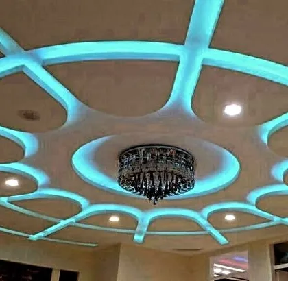 A modern take on a classic pattern. The web-like design is highlighted with cool blue light, and a chandelier in the center completes the look.