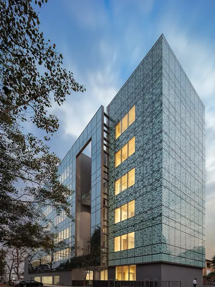 This is Delhi’s first LEED Platinum Commercial Office Building, designed by us. Its north-facing orientation and strategic placement of service cores minimize solar heat gain, ensuring 100% daylighting and creating a 'blinds-free' workspace.