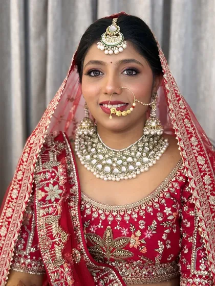 A classic bridal portrait. The makeup is timeless, with a focus on flawless skin and expressive eyes.