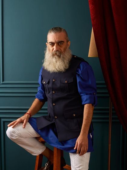 Another look at our navy utility vest paired with a vibrant blue kurta. It’s a confident and contemporary look for the man who likes to mix style with practicality.