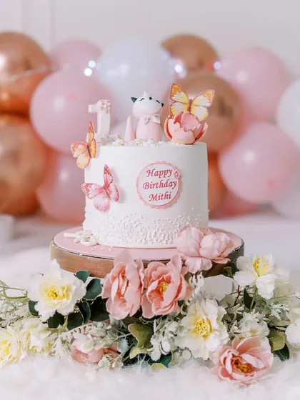 Another gorgeous cake from a first birthday session, this one with delicate butterfly decorations, ready for its big moment.