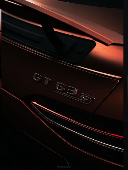 A dramatic, low-light shot of the 'GT 63s' badge on the rear of a Mercedes-AMG. This type of detail-oriented car photography creates a sense of exclusivity and power.