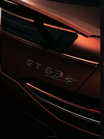A dramatic, low-light shot of the 'GT 63s' badge on the rear of a Mercedes-AMG. This type of detail-oriented car photography creates a sense of exclusivity and power.
