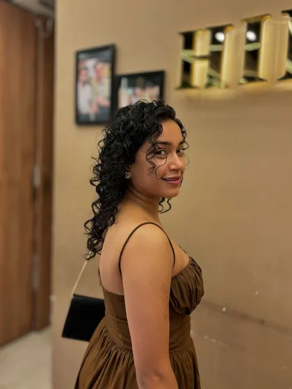 Another angle of a client's curly hairstyle, perfect for any occasion, from casual to formal.