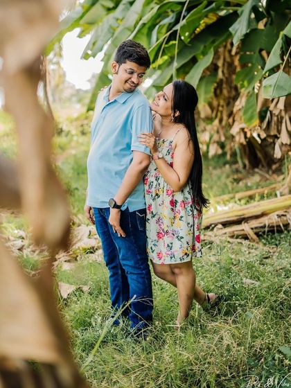 A sweet, candid moment in a lush green banana grove, showcasing a different kind of natural backdrop.