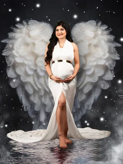 A heavenly portrait where I've added beautiful, soft angel wings to the mom-to-be. This creative touch, combined with the white gown and starry effects, creates a truly angelic image.