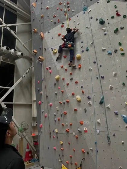 A belayer watches their partner ascend. The view from the ground is just as important as the view from the top.