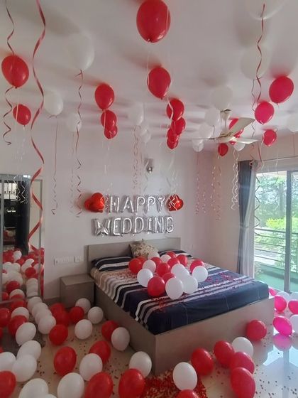 A "Happy Wedding" bedroom decoration with red and white balloons to welcome the newly married couple.